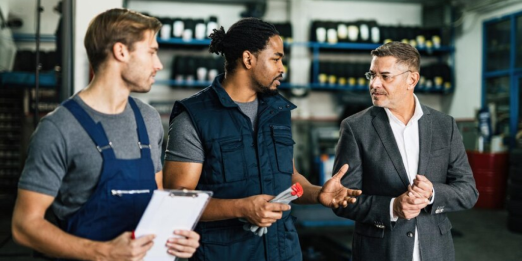The importance of manufacturing is seen here with three people at work talking to one another in their manufacturing jobs.