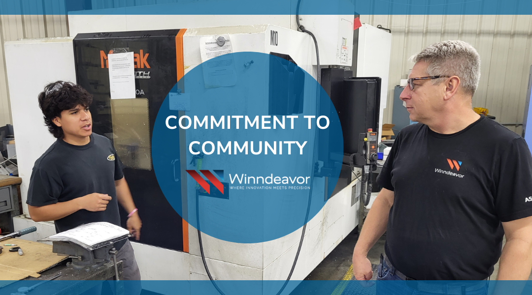 Winndeavor team collaborating in shop with overlay that says "commitment to community" with the Winndeavor logo on it