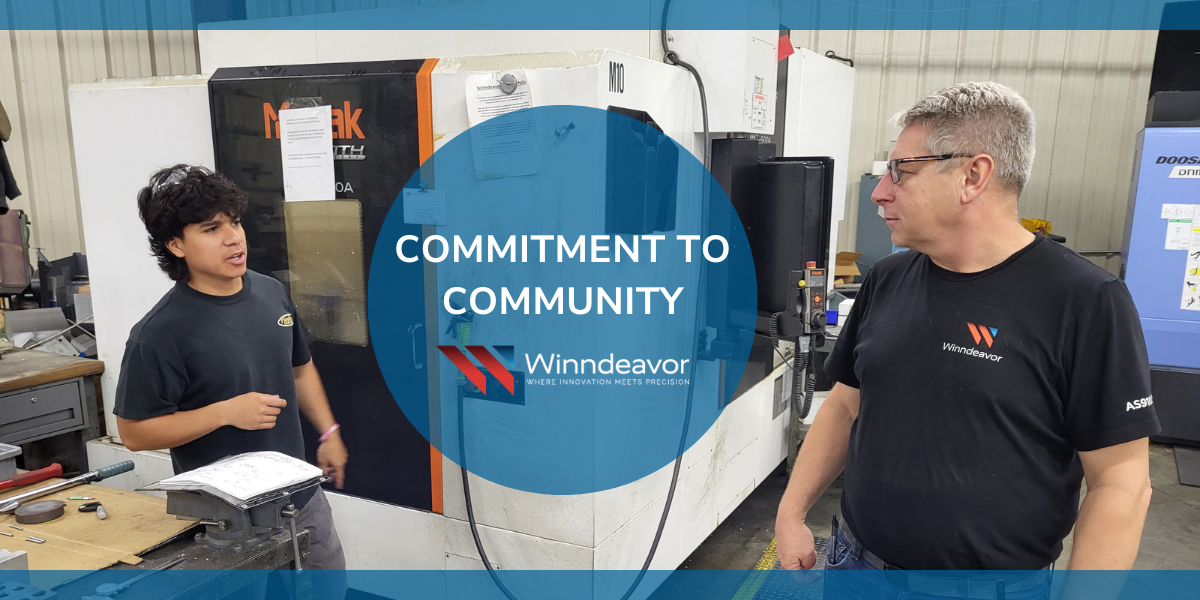 Winndeavor team collaborating in shop with overlay that says "commitment to community" with the Winndeavor logo on it