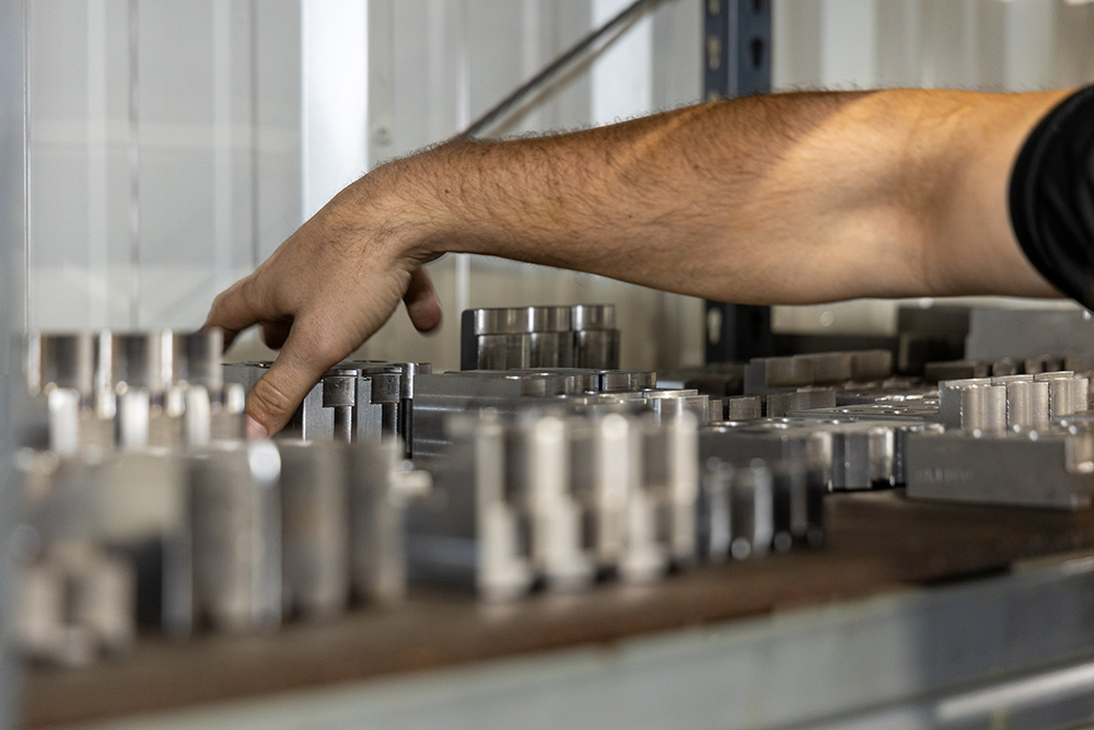 Person handling metal parts in machine shop