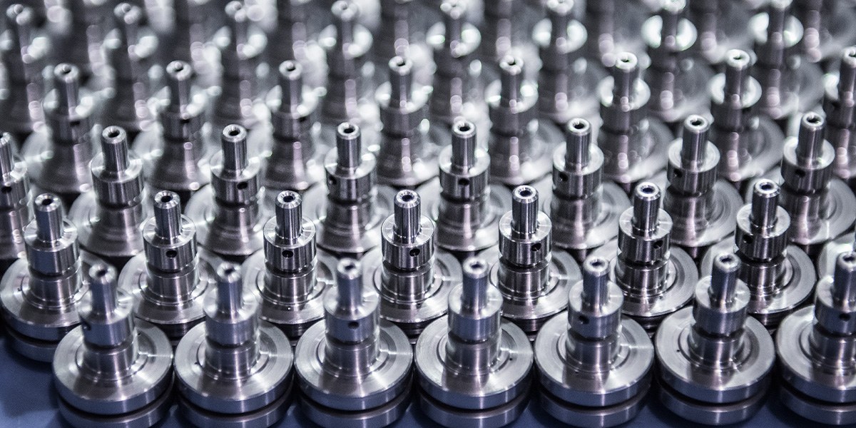 several rows of metal parts lined up and prepared for packaging